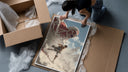 anime soldier battling colossal titan framed print being unpacked from protective bubble wrap and a box