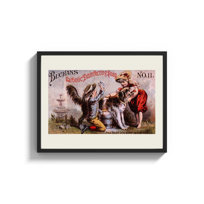 Framed Two children washing a dog print shown as a wide statement piece on a clean white wall