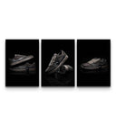 Three dark mocha sneaker poster prints on dramatic black reflective backgrounds displayed side by side