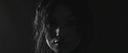 Black and white portrait of a person with a dark background
