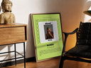 Brass-framed Man covering face album cover print leaning in a warm styled corner by a sculpture