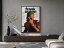 Frank Ocean with green hair poster framed above a wood console in a concrete-wall living room