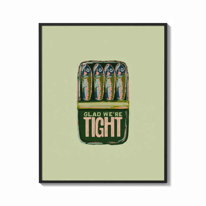 Framed Glad We're Tight Sardine Tin print shown as a bold statement piece on a clean gallery wall