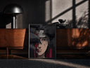 Black-framed Anime ninja with red Sharingan eye print on a moody console with designer coffee-table books