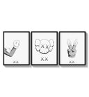 KAWS cartoon hands and skull face three-panel set arranged as a triptych on a bright gallery wall