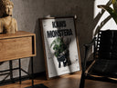 Walnut-framed KAWS Companion figure holding monstera plant print leaning against a sunlit rustic brick wall