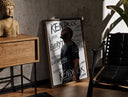 Walnut-framed Man looking upward in profile print leaning against a sunlit rustic brick wall