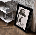 Kevin Durant basketball player portrait poster in a black frame leaning beside a shelf in a raw-plaster loft