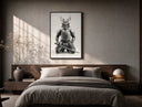 Skeletal samurai in metallic armor poster framed above the bed in a warm minimalist bedroom
