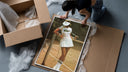 Lacoste vintage tennis framed print being unpacked from protective bubble wrap and a box