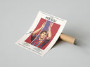 Woman unpacking framed Lionel Messi Barcelona Portrait from cardboard box with bubble wrap on concrete floor