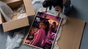 Woman in pink top fan art framed print being unpacked from protective bubble wrap and a box