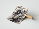 A panel of the Three ninja characters triptych portrait set rolled beside its kraft shipping tube