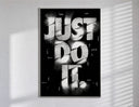 Just Do It typography design poster in a slim frame on a bright wall with soft window light