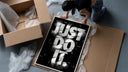 Just Do It typography design framed print being unpacked from protective bubble wrap and a box