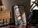 Walnut-framed Nami from One Piece anime print leaning against a sunlit rustic brick wall