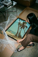 The Beach scene with palm trees and surfers poster shown across its range of print sizes