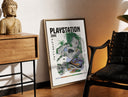 Brass-framed Overgrown PlayStation console with controller print leaning in a warm styled corner by a sculpture