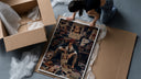 Red-haired pirate man sitting framed print being unpacked from protective bubble wrap and a box