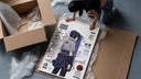 Sasuke Uchiha standing with sword framed print being unpacked from protective bubble wrap and a box