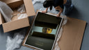 Se7en box scene framed print being unpacked from protective bubble wrap and a box