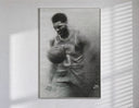 Basketball player celebrating with ball poster in a slim frame on a bright wall with soft window light