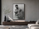Basketball player celebrating with ball poster framed above a wood console in a concrete-wall living room