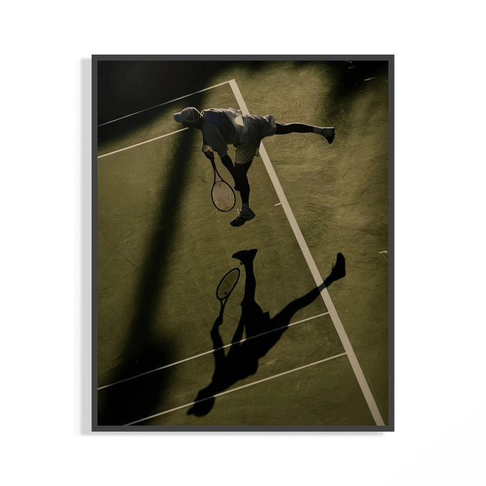 Aerial tennis poster of a player at the top of a serve with a long court shadow displayed on a wall