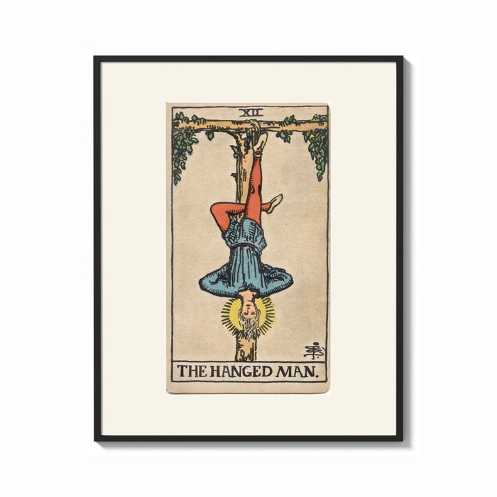 Framed Man hanging upside down from tree print shown as a bold statement piece on a clean gallery wall