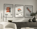 Three black-framed SEAxFOOD Market Japanese sushi posters hung on white wall above sideboard with dark ceramic vases and trailing plants