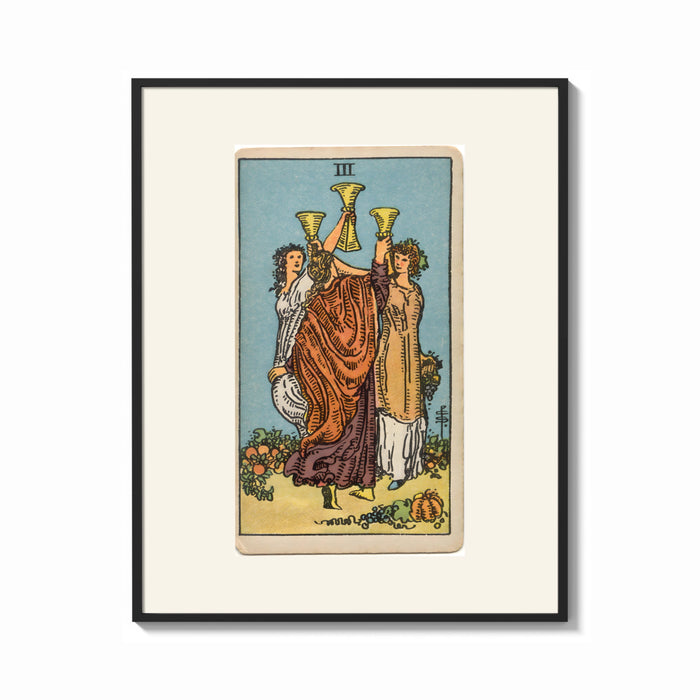 Framed Three women toasting golden cups print shown as a bold statement piece on a clean gallery wall
