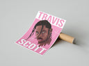Woman unboxing a framed Travis Scott Cactus Jack Portrait with pink background from cardboard packaging on concrete.
