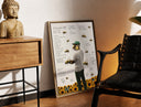 Brass-framed Man with bees on face, back turned print leaning in a warm styled corner by a sculpture