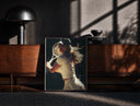 Black-framed vintage tennis serve print on a moody console with designer coffee-table books