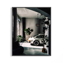 White Porsche 911 sports car parked in a modern industrial loft with concrete floors and pendant lights
