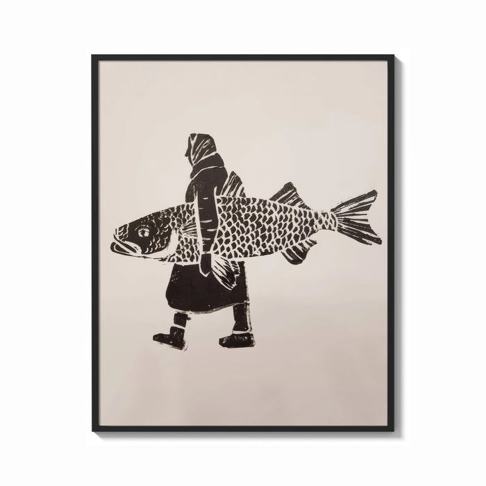 Framed Woman Carrying a Giant Fish print shown as a bold statement piece on a clean gallery wall