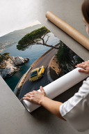 Porsche 911 Yellow Amalfi Coast Road - Luxury Sports Car Wall Art unframed poster print leaning against a cardboard tube o...