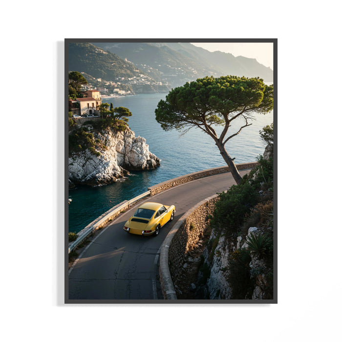Yellow Porsche 911 driving a curved coastal road above the Mediterranean sea with cliffs