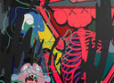 KAWS abstract pop art mural with red skeleton figure, neon green linework, and vibrant layered characters in pink, blue, and yellow