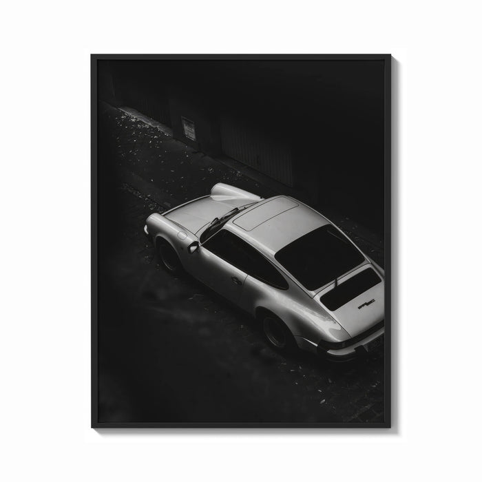 Framed Silver Porsche 911 parked in alley print shown as a bold statement piece on a clean gallery wall