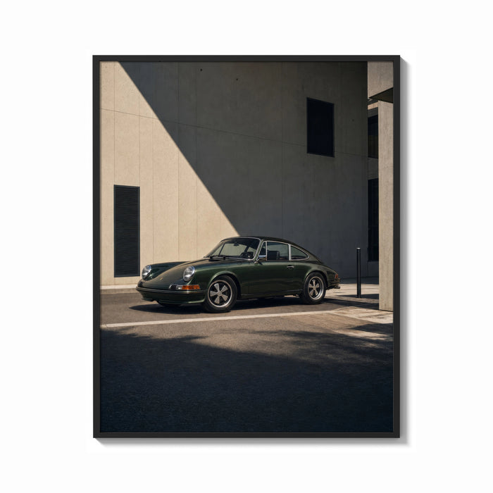 Framed Vintage green Porsche 911 coupe print shown as a bold statement piece on a clean gallery wall