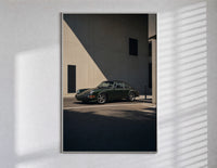 Vintage green Porsche 911 coupe poster in a slim frame on a bright wall with soft window light