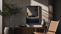 Vintage green Porsche 911 coupe poster framed above a fluted sideboard beside an olive tree