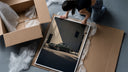 Vintage green Porsche 911 coupe framed print being unpacked from protective bubble wrap and a box