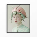 Framed artwork of a person wearing a large beetle-like helmet with pink shell and green body.