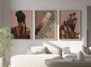 Abstract Black Woman Art Set of 9 printable art featuring Afrocentric designs in warm tones above sofa in modern living room — Haus of Prints.