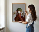 Woman holding the Black Art Printable Fashion Poster, preparing to hang it in her space.