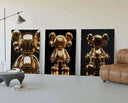 Display of three Hypebeast Gold Posters Set with shiny KAWS art in an elegant room setting.