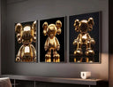 Set of three gold KAWS posters from Hypebeast, showcasing different poses in a modern interior.
