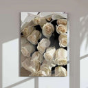 Close-up of a hand adorned with stylish nail art, holding a drink next to chic accessories in wall art.